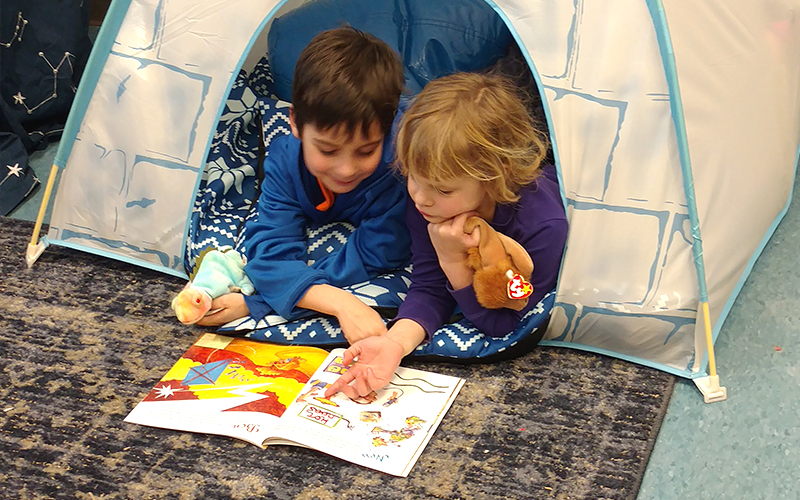 Two students read a book together