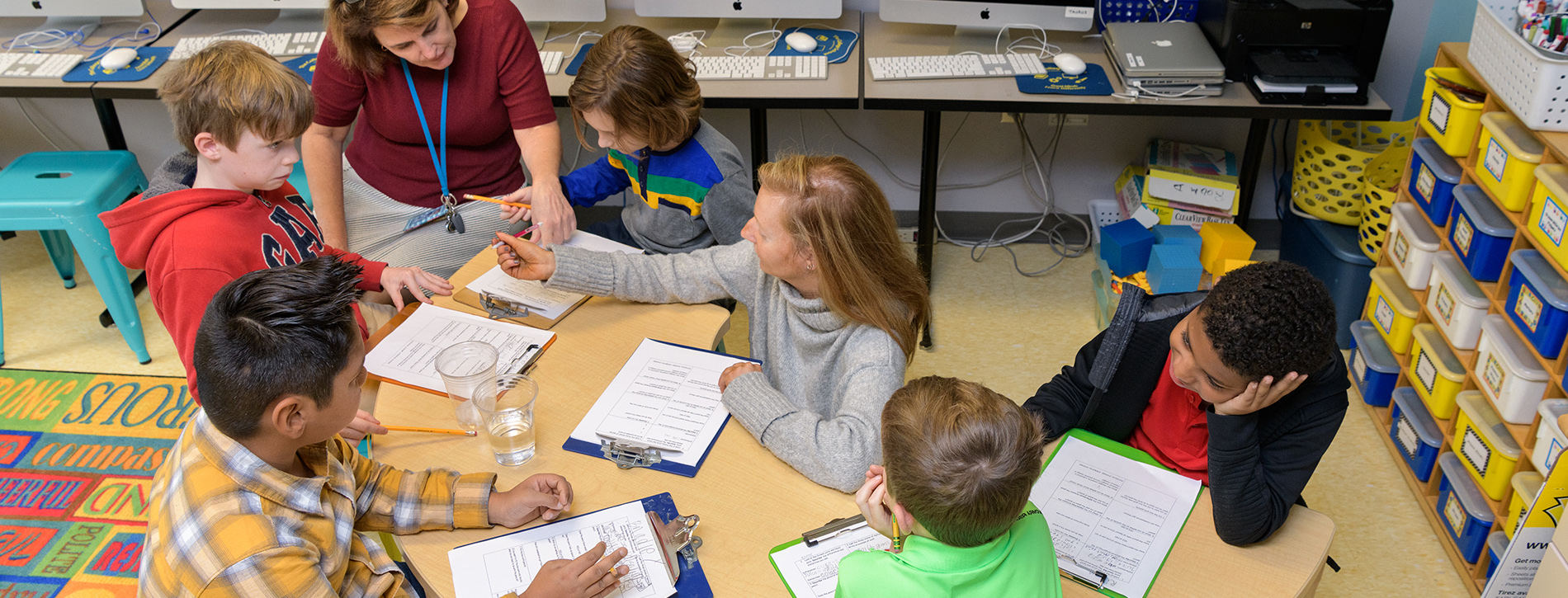 Two teachers work with students at The College School