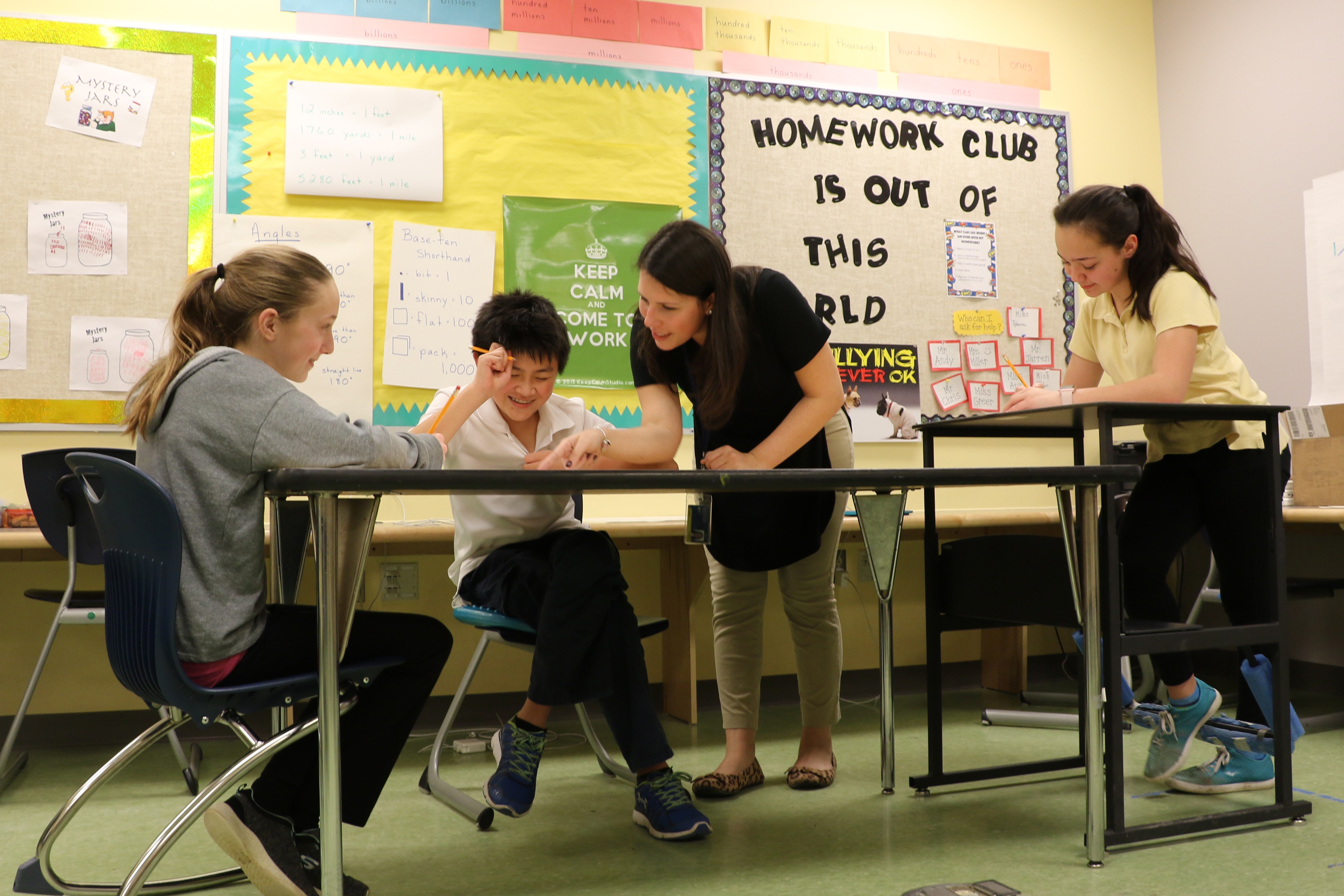 Teacher works with three students in The College School