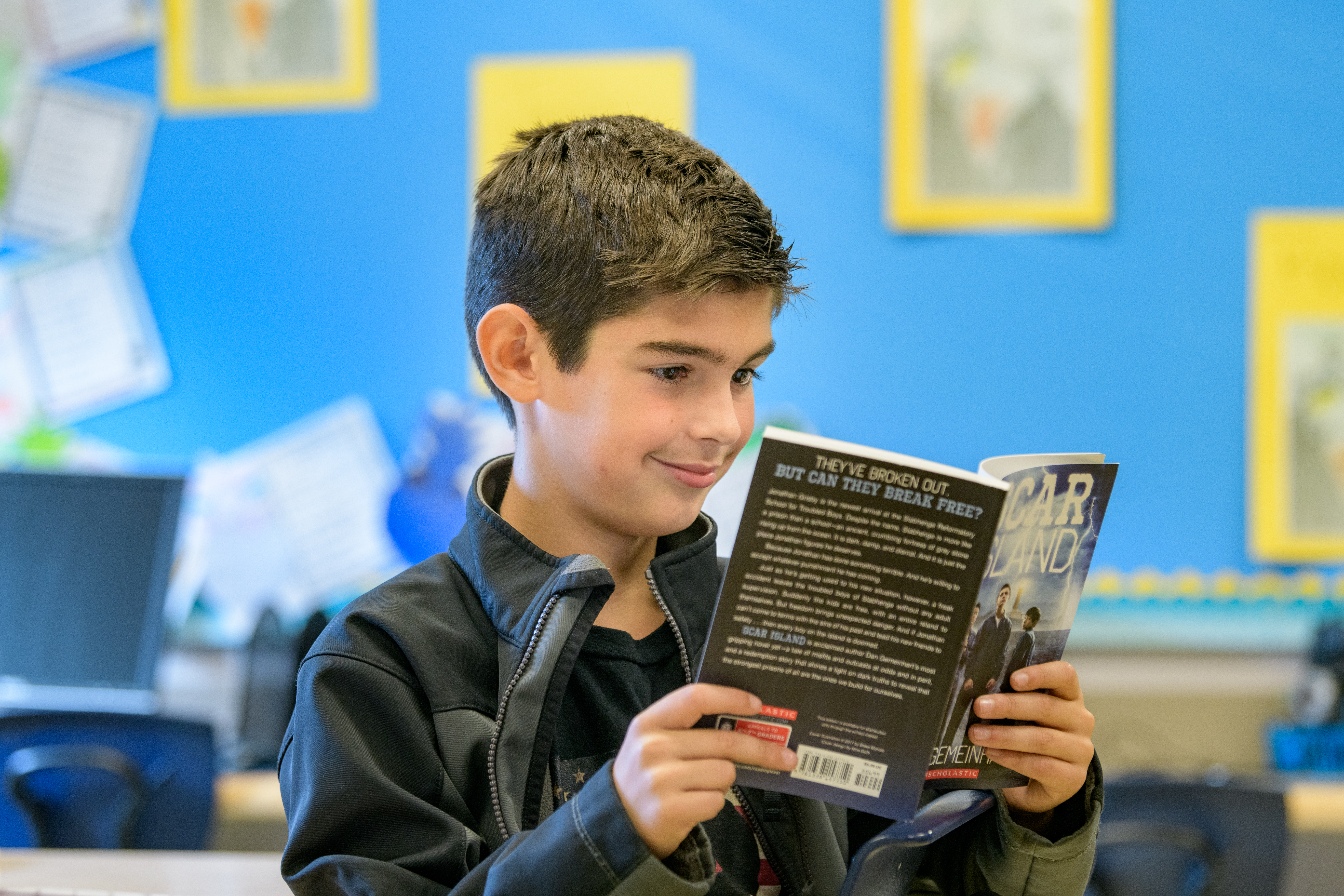 Student reads book in class at The College School