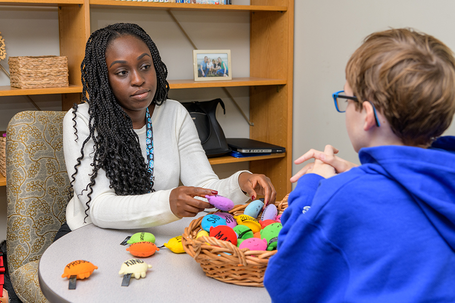 School psychologist speaks with student at The College School