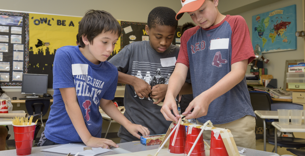 three boys working on a STEAM project together